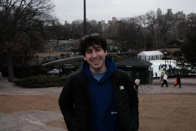 Nadav Avital outdoors in a blue hoodie and black jacket
