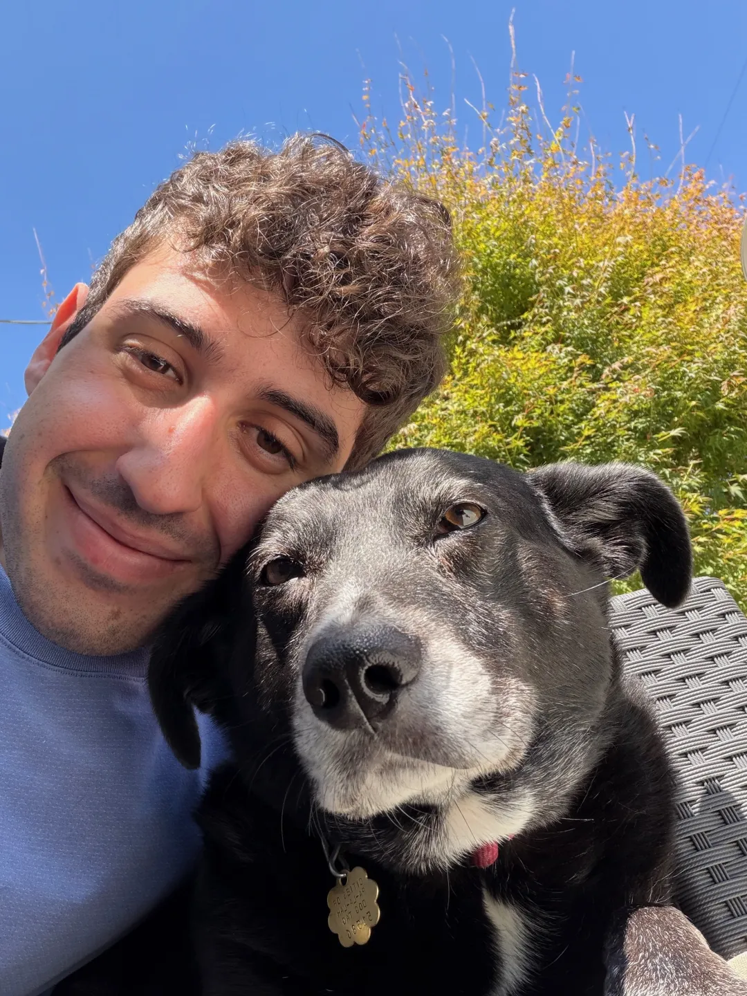 Nadav Avital outdoors with his dog Booba